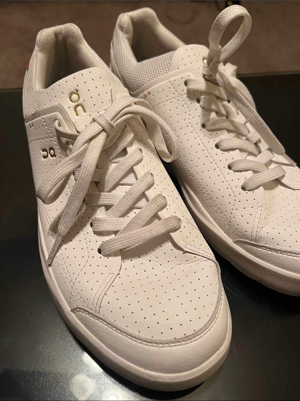 On Running Women’s “The Roger” White  Leather Sneakers with Gold Logo
